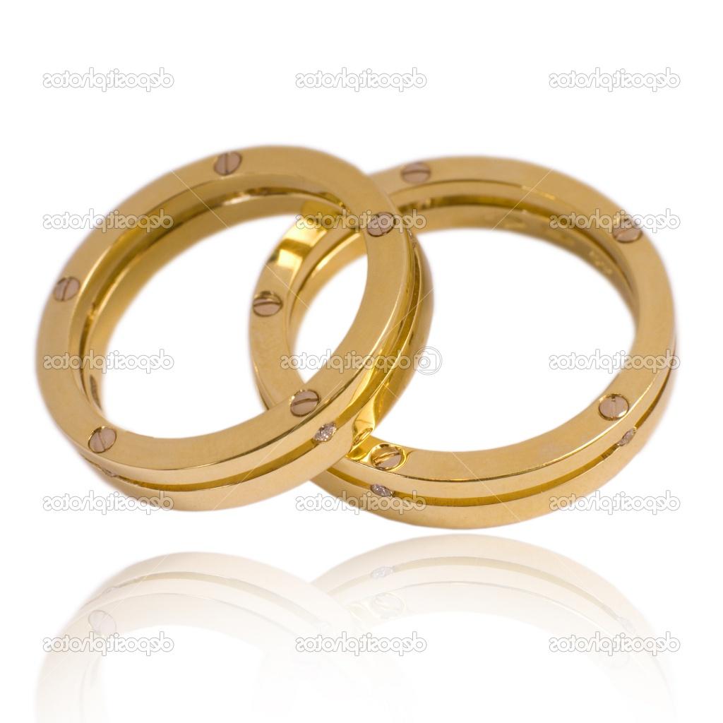 His and hers golden wedding bands, with diamonds. On a white background with