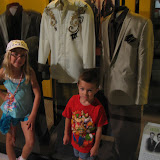 Hannah and Bryan standing by suits that members of Rascal Flats wore in the Country Music Hall of Fame in Nashville TN 09042011