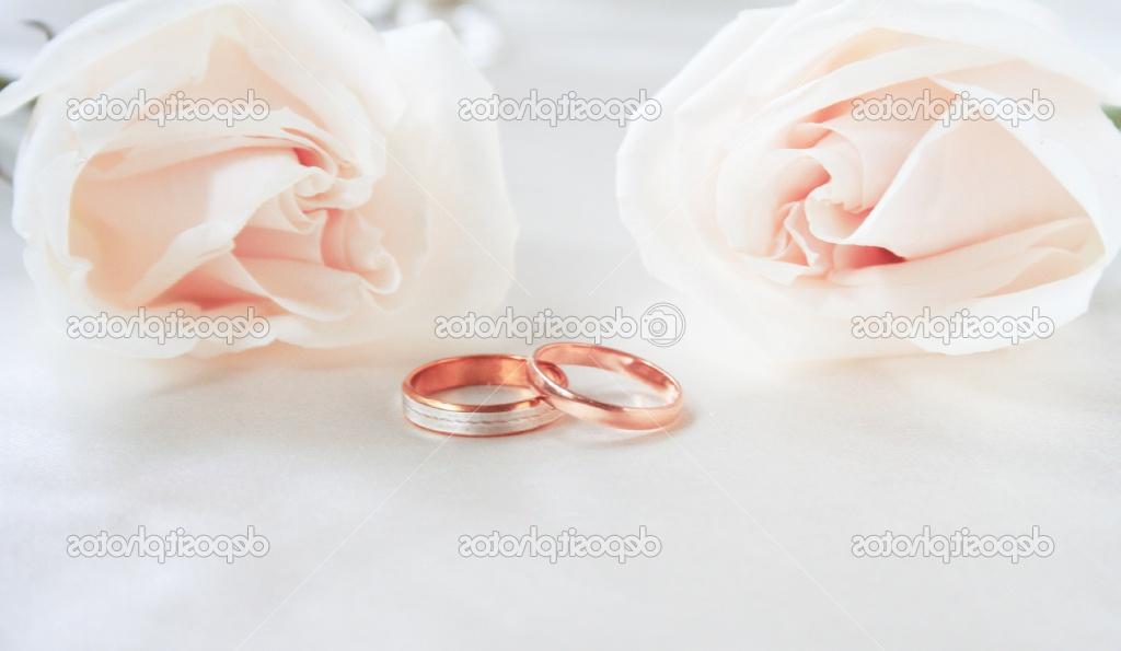 Wedding rings and roses as wedding background