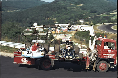 Марк Донохью и Джон Уотсон в болидах March и Lotus едут на грузовике по Нюрбургрингу на Гран-при Германии 1975