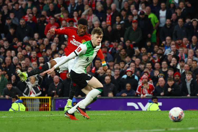 Manchester United’s Amad Diallo scores their fourth goal in the FA Cup quarterfinal against Liverpool at Old Trafford in Manchester on Sunday. Picture: MOLLY DARLINGTON/REUTERS
