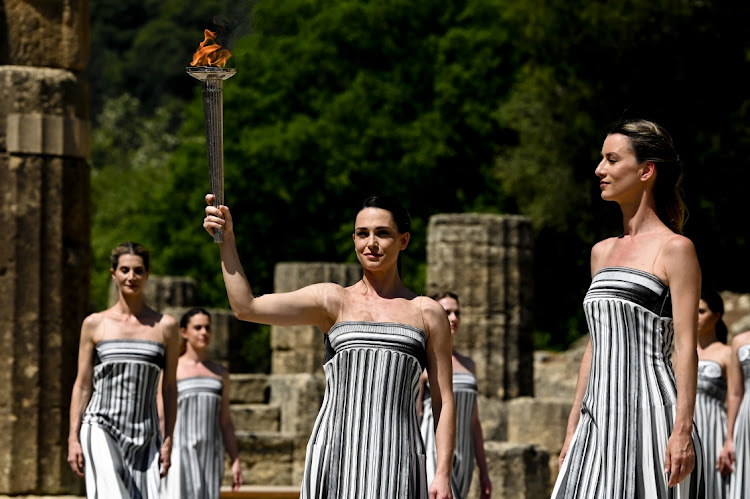 Greek actress Mary Mina, playing the role of the High Priestess, holds the torch during the dress rehearsal for the flame-lighting ceremony for the Paris 2024 Summer Olympics at the Ancient Olympia archeological site, birthplace of the ancient Olympics in southern Greece in Olympia, Greece on Monday.