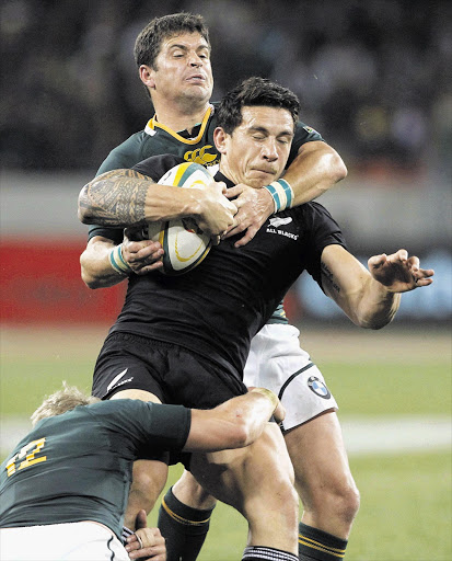 Sonny Bill Williams of New Zealand's All Blacks is tackled by Morne Steyn (top) and Jean De Villiers of South Africa during the Tri-Nations match in Port Elizabeth on Saturday. The Springboks won 18-5 with Steyn scoring all 18 points Picture: MIKE HUTCHINGS/GALLO IMAGES