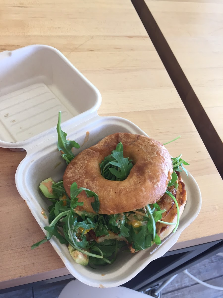 Bagel with egg, avocado, arugula, and spicy chipotle aioli