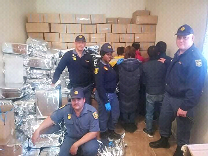 Members of the SAPS in the Northern Cape and the arrested suspects who are accused of allegedly selling counterfeit goods in Hartswater on July 17 2018