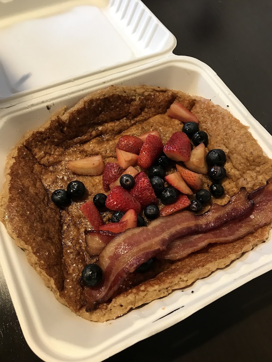 OATMEAL PANCAKE - Our gluten-friendly pancake is housemade with freshly ground rolled oats, topped with strawberries, blueberries and powdered sugar