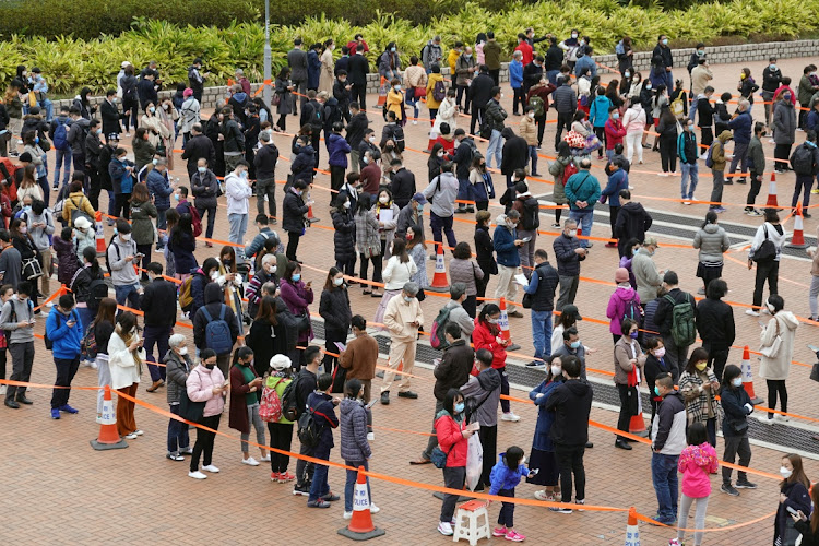 People queue at a makeshift nucleic acid testing centre for the coronavirus disease (COVID-19), at the Central district in Hong Kong, China, February 9, 2022.