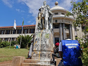 An orientation monitor sits next to the defaced statue of King George V following disruptions at UKZN's Howard College on Monday