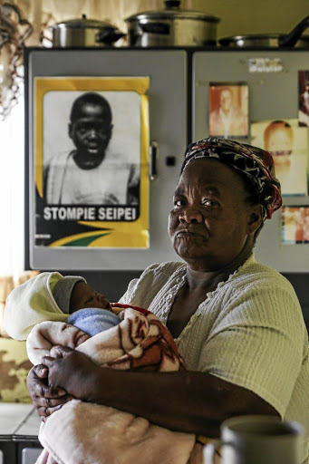 Stompie Seipei's mother, Joyce, 62, with her grandson Keratilwe Paki at her home in Tumahole, Parys.