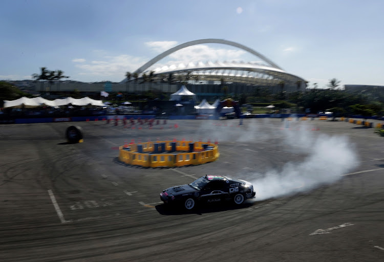 A drifter shows off his skills against the backdrop of Moses Mabhida Stadium.