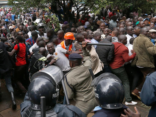A police office disperses Cord supporters who turned up to storm IEBC offices at Anniversary towers and eject the commissioners on April 25, 2015. Photo/Jack Owuor