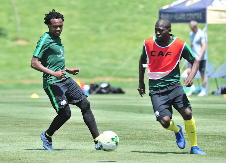 Bafana Bafana players Percy Tau (L) and Aubrey Modiba (R) take part in a training session at Steyn City School in Fourways, north of Johannesburg, on October 9, 2018 .