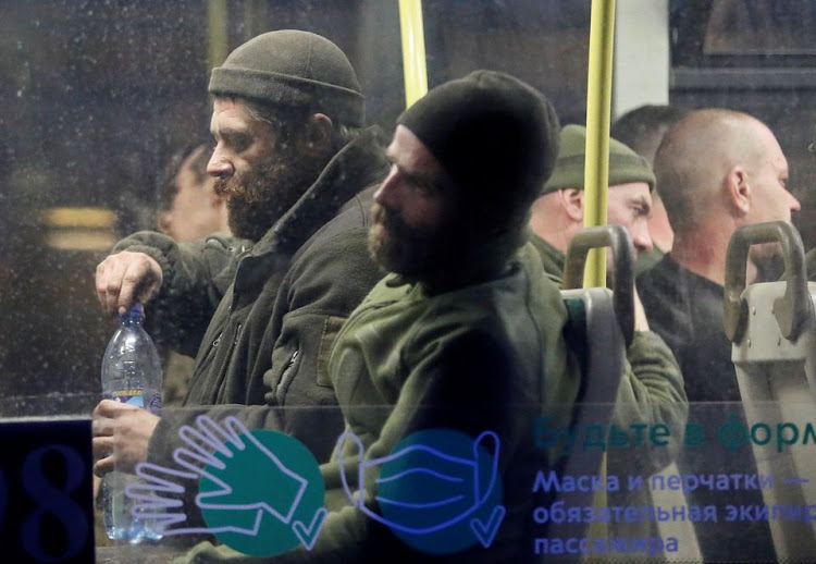 Service members of Ukrainian forces who have surrendered after weeks holed up at Azovstal steel works are seen inside a bus, which arrived under escort of the pro-Russian military at a detention facility in the course of Ukraine-Russia conflict in the settlement of Olenivka in the Donetsk Region, Ukraine May 17, 2022.