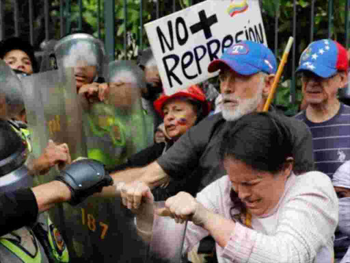 "No more repression" reads a banner held during the "Grandparents March" in Caracas. REUTERS