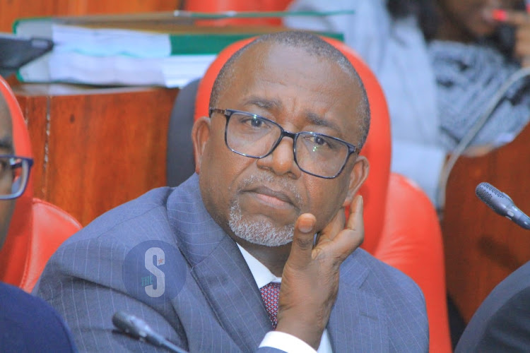 Agriculture Cabinet Secretary Mithika Linturi touches his jawline as the National Assembly select committee holds impeachment pre-trial at County Hall on May 7, 2024.