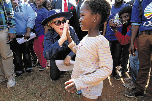 Five-year-old Orange Farm resident Unathi Mwelase welcomes DA leader Helen Zille to the township ahead of yesterday's rally, which marked the first anniversary of the youth wage subsidy march to Cosatu House in Braamfontein, Johannesburg, last year