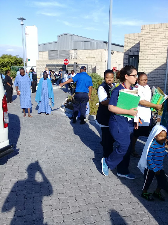 Patients and staff evacuate Mitchells Plan District Hospital in Cape Town early on Saturday after fire broke out in the roof void. Image: City of Cape Town