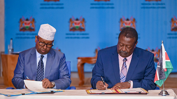 Prime Cabinet Secretary Musalia Mudavadi with Somalia’s Minister for Foreign Affairs and International Cooperation Ahmed Moalin Fiqi during the signing of key MoUs at the closure of the 3rd Session of the Kenya - Somalia Joint Commission for Cooperation (JCC) at a Nairobi Hotel on May 6, 2024.