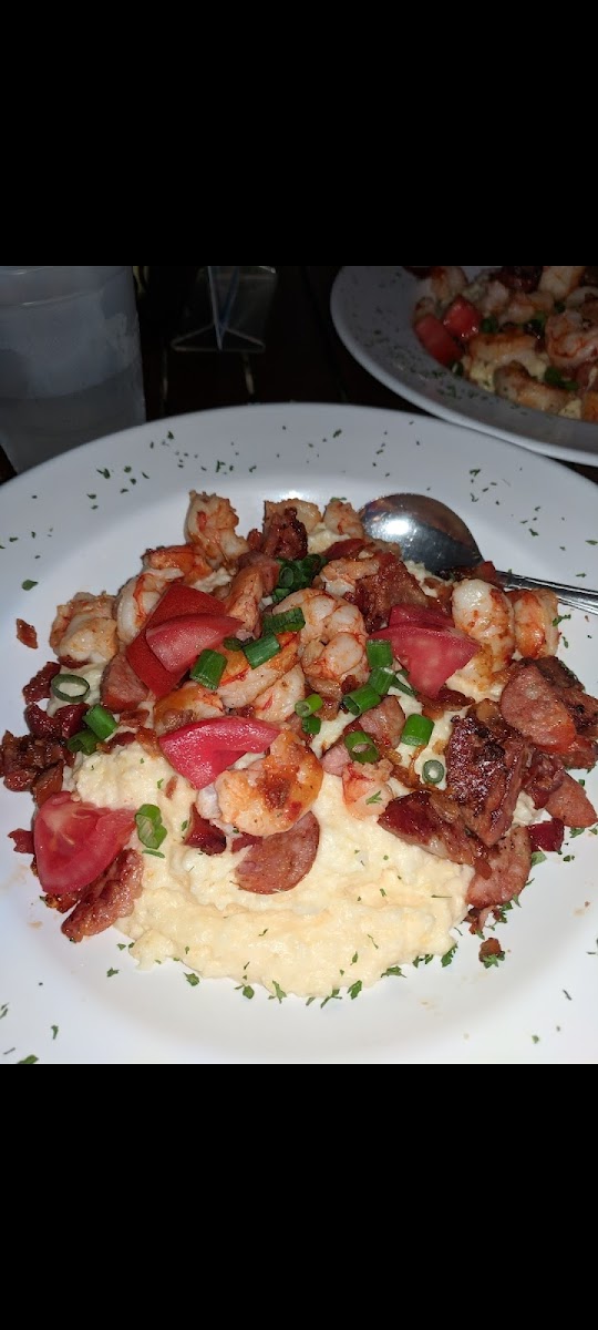 Shrimp n Grits
Sometimes they change the sausage, so ask if it's GF.  Remind them not to give you bread.  I always ask for extra tomatos on the side in place of the sausage.