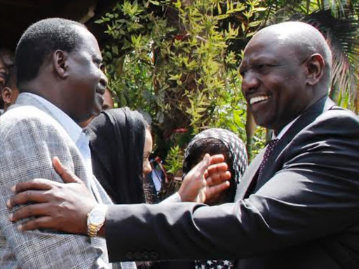 REACHING OUT: Deputy President William Ruto consoles former PM Raila Odinga after the death of his son Fidel at his Karen home. FILE