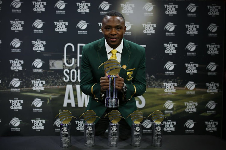 SA Cricketer of the Year Kagiso Rabada poses for photographs with his trophies.