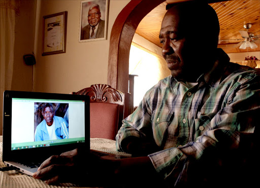 ANGUISH: Nkrumah Phala looks at the picture of his missing brother Charles at their family home in Diphagane village in Limpopo. The portrait of their late father and struggle stalwart, Mahwidi Phala, is mounted on the wall Photos: SANDILE NDLOVU