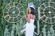Zuri Hall from E entertainment wore a classy white dress and fascinator at The Vodacom Durban July.