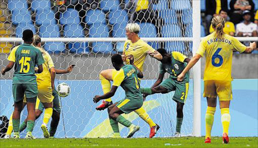 SHARP SHOT: Nilla Fischer of Sweden scores the winner against Noko Matlou and Lebohang Ramalepe of Banyana Banyana during their first round match last night Picture: GETTY IMAGES