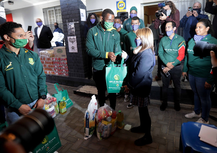 Springboks captain Siya Kolisi handout food parcels, and other items at Peakview Secondary School, Athlone, Cape Town, on Thursday.
