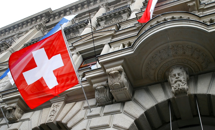 Switzerland's national flag flies outside a building in Zurich. Picture: REUTERS/ARND WIEGMANN