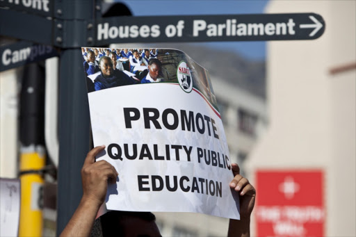 Members of the South African Democratic Teachers Union protest outside of parliament on April 24, 2013 in Cape Town, South Africa.