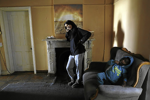 Zoe Mayekiso and one of her siblings inside their Crown Mines home.