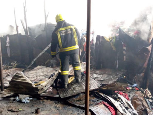 A firefighter at the scene of a fire which gut stalls at Gikomba market, Nairobi on Wednesday, November 7, 2018. /COURTESY