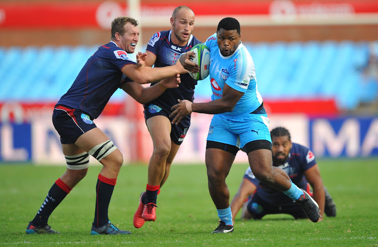 Lizo Gqoboka of the Vodacom Blue Bulls is tackled by Billy Meakes of Rebels during the Super Rugby match at Loftus Versfeld Stadium.
