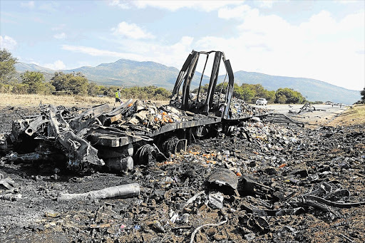 The burnt-out remains of a truck that exploded on the N1 highway between Mokopane and Polokwane, Limpopo, in the early hours of yesterday morning, killing four policemen and a truck driver.