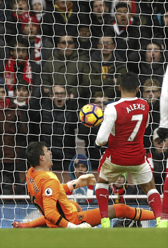 Arsenal’s Alexis Sanchez scores the first of his two goals against Hull yesterday.