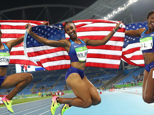 Brianna Rollins of USA celebrates winning the gold medal with silver medallist Nia Ali and bronze medallist Kristi Castlin, both from USA, after the 100m hurdles in Rio de Janeiro, August 17, 2016. REUTERS