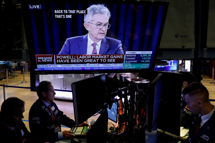 Traders work as a screen shows US Federal Reserve chairman Jerome Powell, on the floor of the New York Stock Exchange in New York, US. File photo: BRENDAN MCDERMID/REUTERS