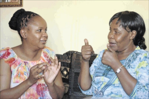 signed bond: Sylvia Manganye and her adoptive mother Senzi Motha use sign language to communicate with each other and other people coming to Motha's house for help photos: vicky somniso-abraham