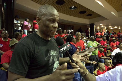 Sthembiso Tembe, chairperson of NEHAWU parliament wit workers in the public gallery where workers disrupted a sitting of the National assembly, Cape Town. Picture Credit:Trevor Samson