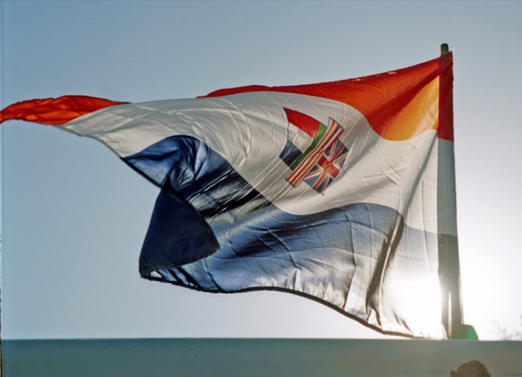 The old, orange and blue South African flag, reminiscent of Apartheid days, flapping in the wind.