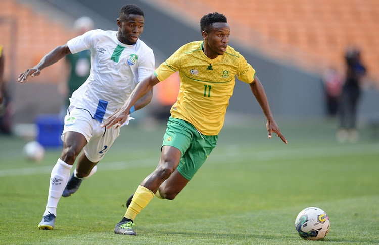 Augustus Kargbo of Sierra Leone chases Bafana Bafana's Themba Zwane in the international friendly at FNB Stadium on September 24 2022.