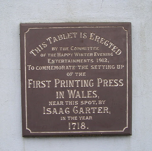 Plaque commemorating the first printing press in Wales, erected by the committee of the Happy Winter Evening Entertainments, 1912. © Copyright Marion Phillips and licensed for reuse under this...