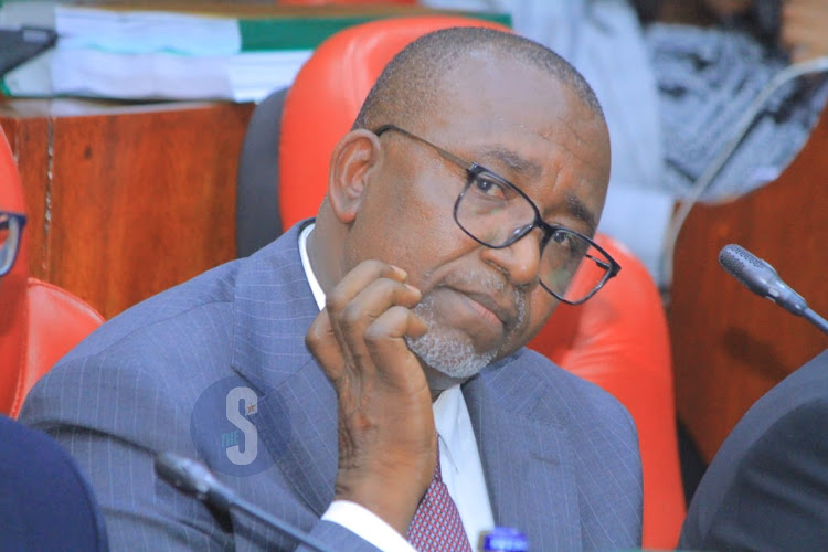Agriculture Cabinet Secretary Mithika Linturi scratches his jawline as National Assembly select committee holds impeachment pre-trial hearing at County Hall on May 7, 2024.