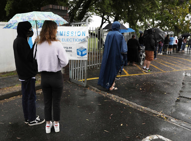 Voters queue in the rain to cast their vote in Pinelands, Cape Town, on Monday.