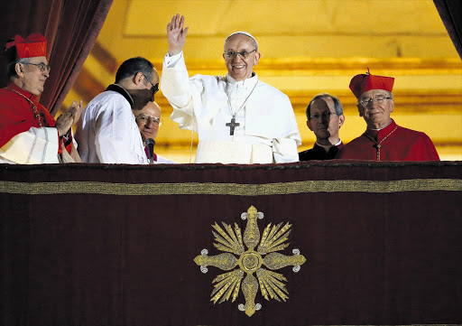 Newly elected Pope Francis I waves to the waiting crowd from the central balcony of St Peter's Basilica in Vatican City last night. Argentinian Cardinal Jorge Mario Bergoglio is the 266th pontiff to lead the world's 1.2 billion Catholics