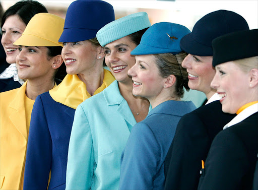 Flight attendants dressed in uniforms from the last 50 years smile during a celebration of the German airline Lufthansa at the Franz-Josef Strauss Airport April 1, 2005 in Munich, Germany. (File photo.)