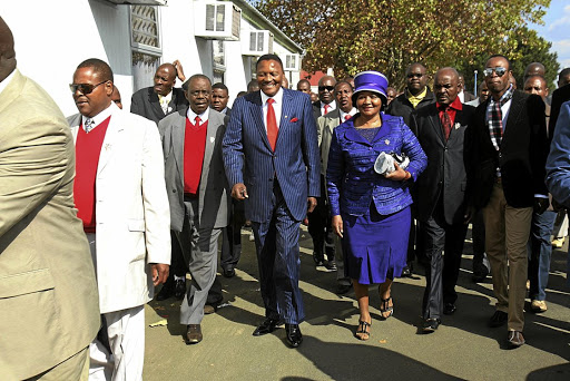 The late Glayton Modise and his wife Mirriam leave the Protea Magistrate's Court with a large entourage.