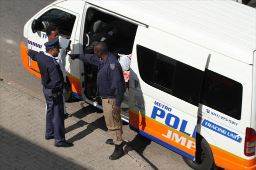 Johannesburg Metro police officers at the crime scene where a metro police officer was shot on May 22, 2013 in Alexandra, South Africa. A metro police officer was shot and wounded by armed men in Alexandra yesterday.