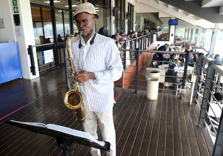 Sibonelo Kodisang plays the saxophone at the Joburg Seafood & Jazz Racing Festival.